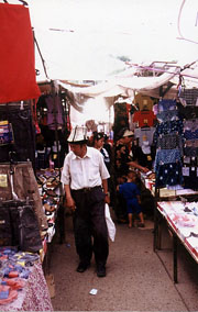 Man mit kirgisischen Hut auf einem Markt